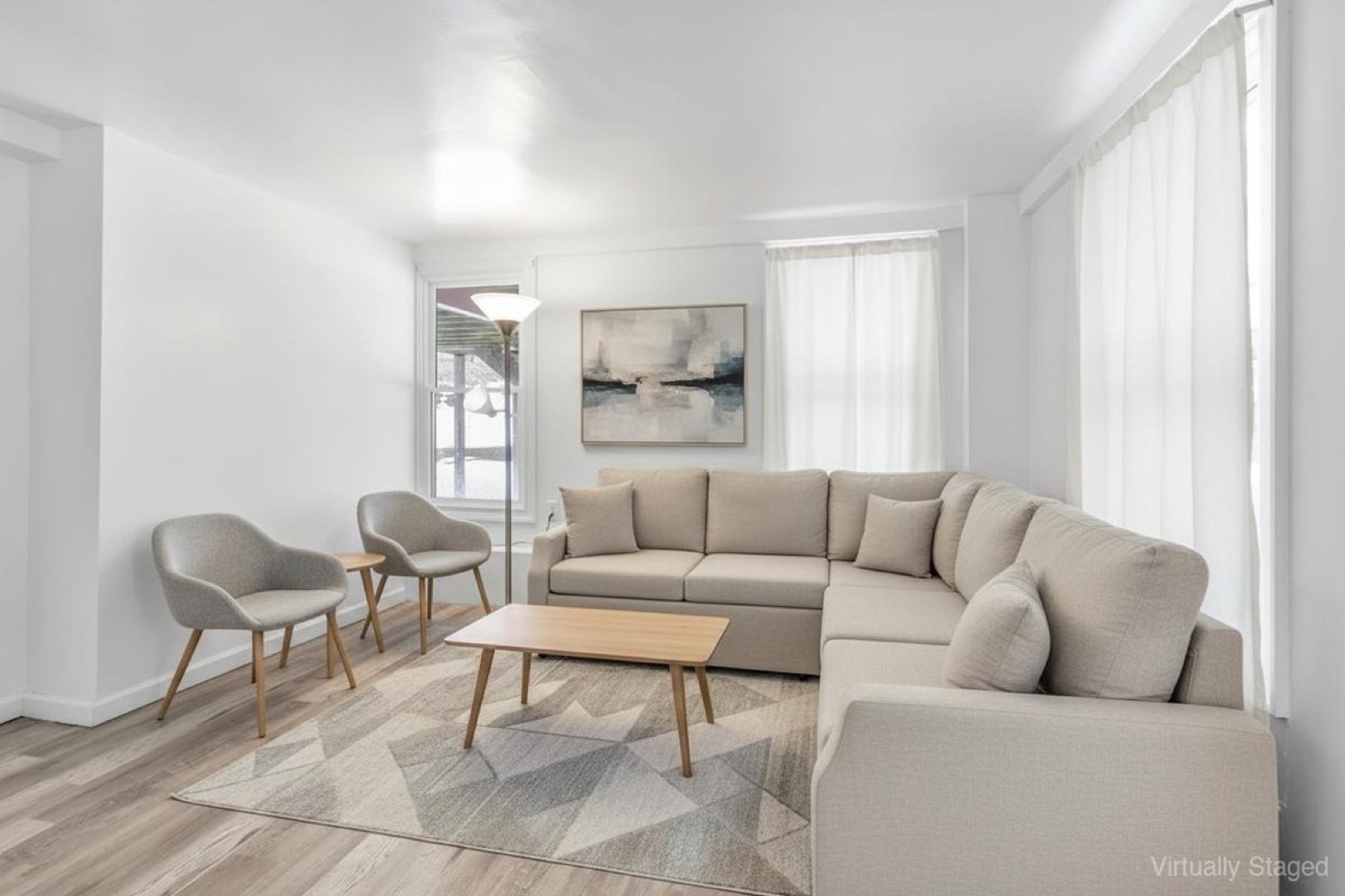 Naugatuck CT basement sitting area after virtual staging with sofa and decor