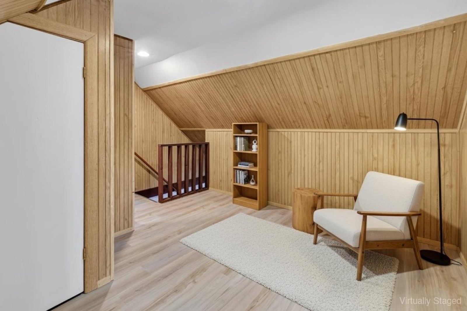 Naugatuck CT upstairs reading nook after virtual staging with accent chair and bookshelf