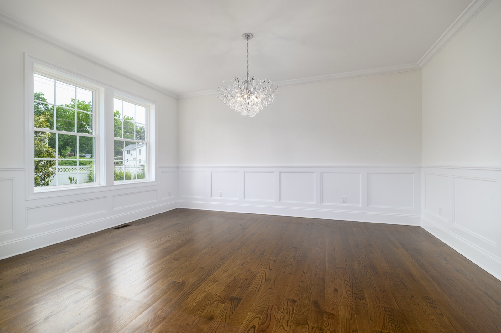 Empty Stamford CT formal dining room with chandelier before virtual staging